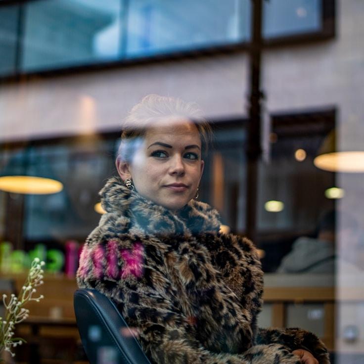 Kaveri Mehta, Lead Design Curator at HarborYardStudio, reviewing corporate floral arrangements